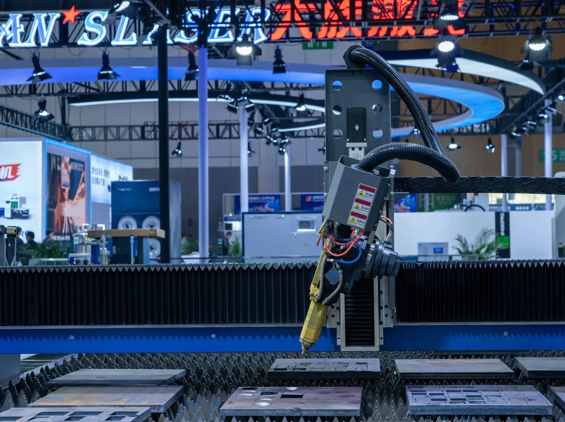 A CNC laser cutting machine running at an industrial exhibition