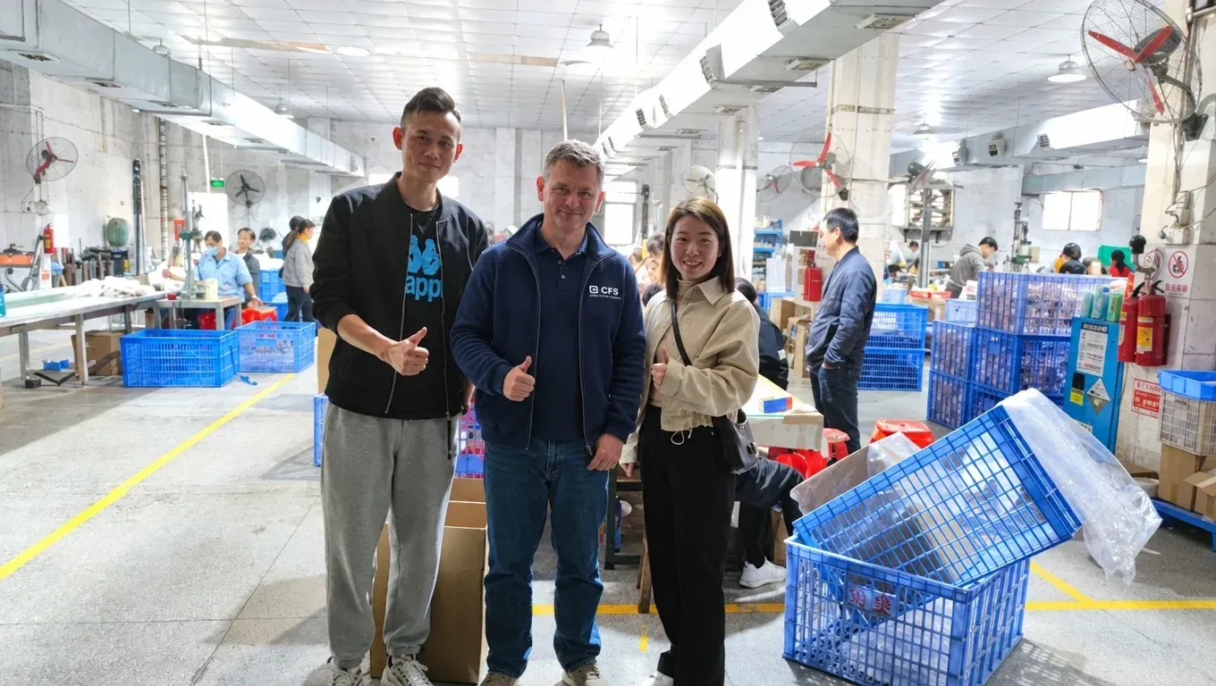 CFS co-founder Noel Murphy with colleagues on a factory floor in China