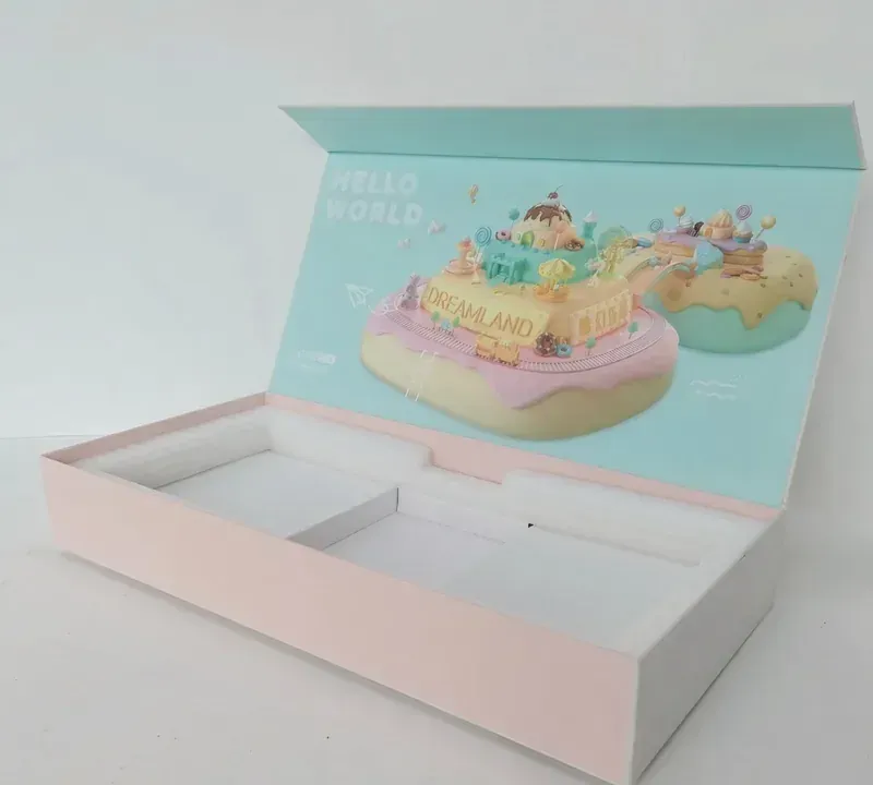 A pastel gift box with an illustrated lid and a white foam insert